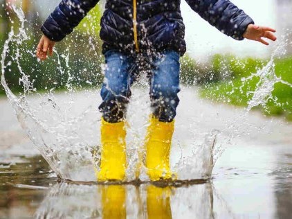 Child Jumping in Puddle