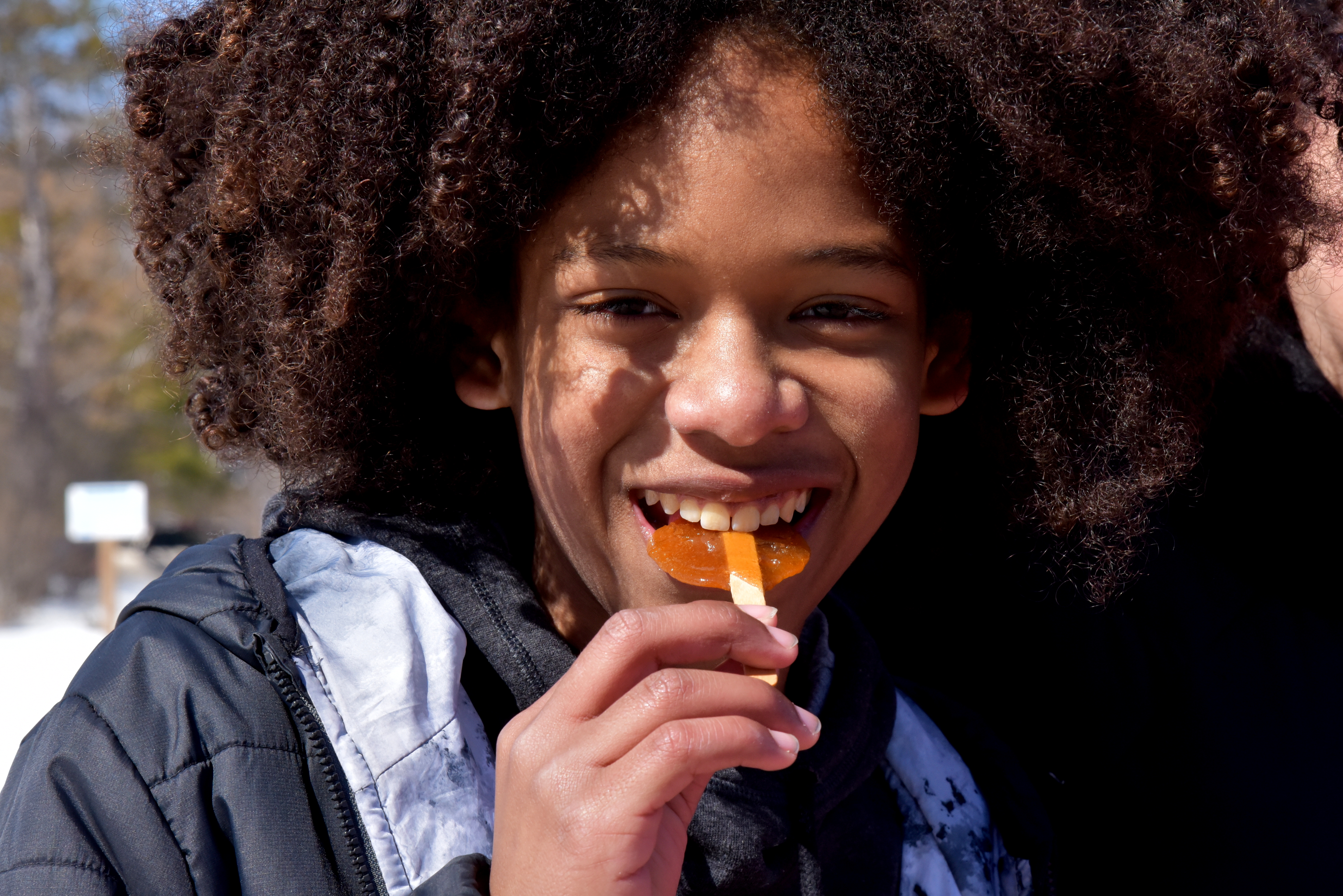 Young boy eating maple candy