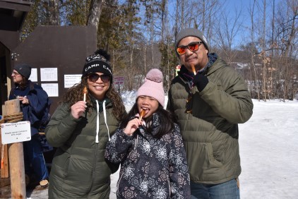 Family eating maple syrup taffy