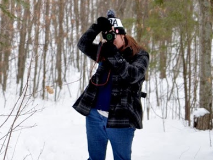 Hiker standing in Forest taking picture