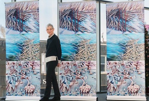 Artist standing with store front work