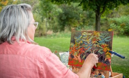 woman painting an image from the back