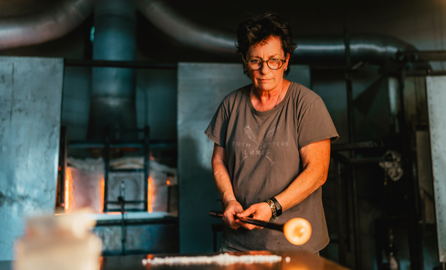 A person blowing glass