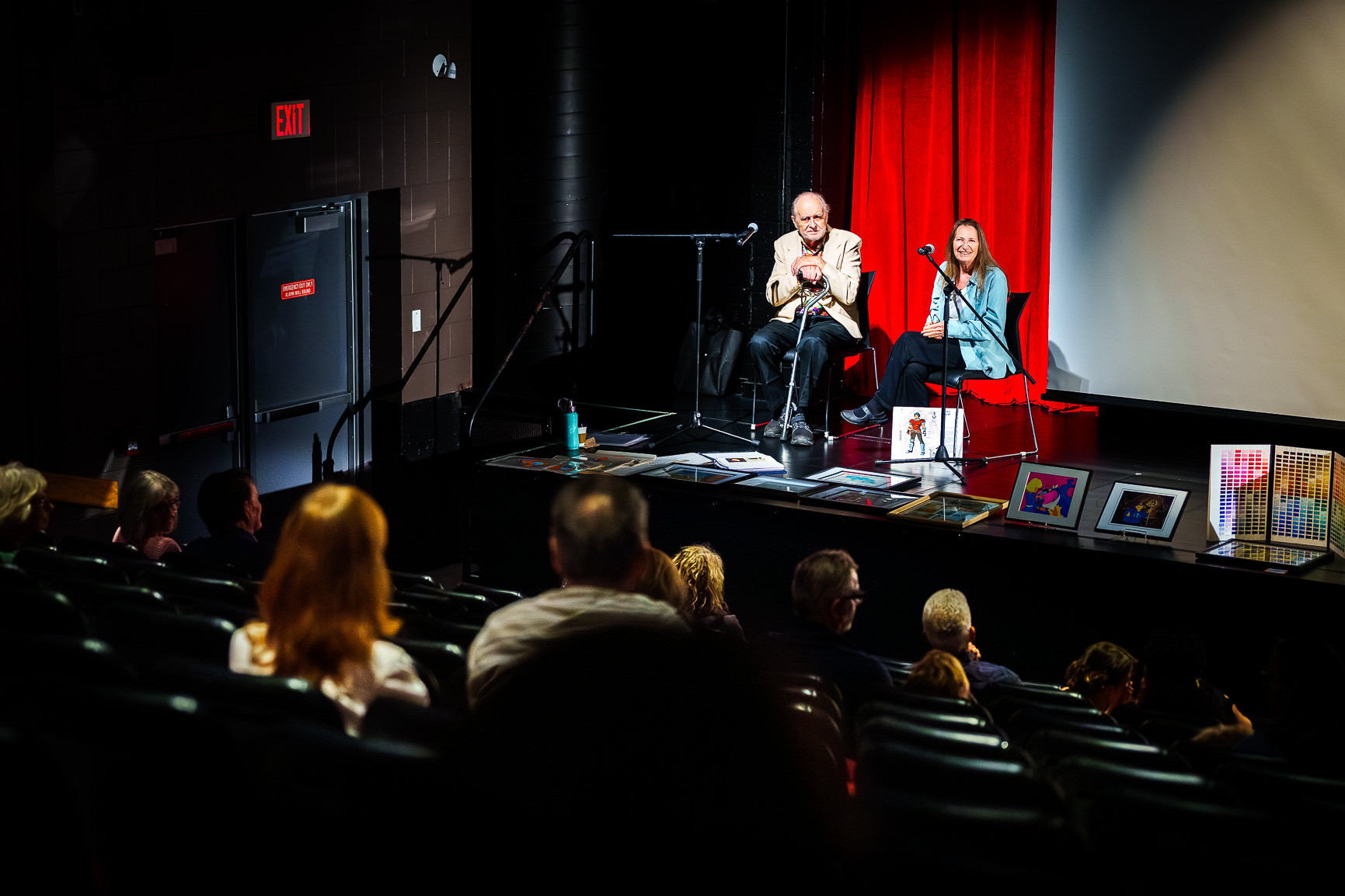 Two people giving a lecture on stage