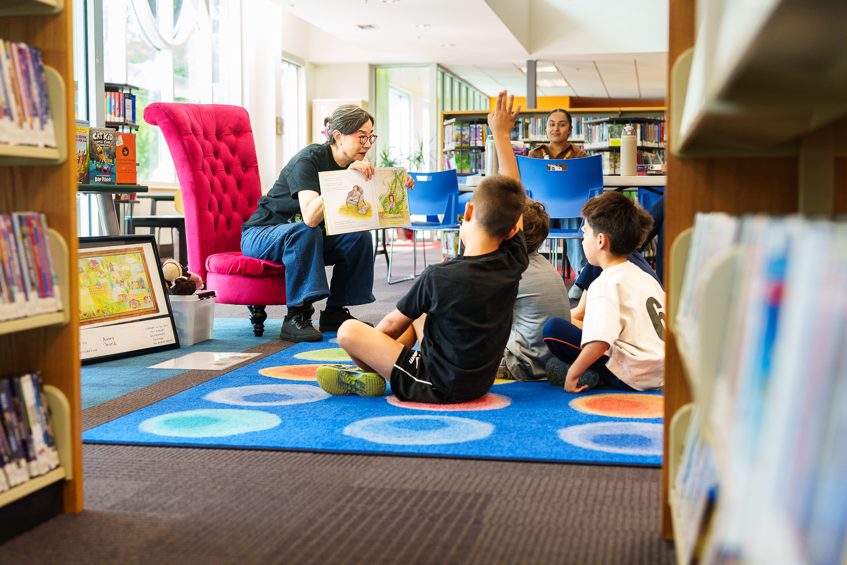 A woman reading for a group of kids
