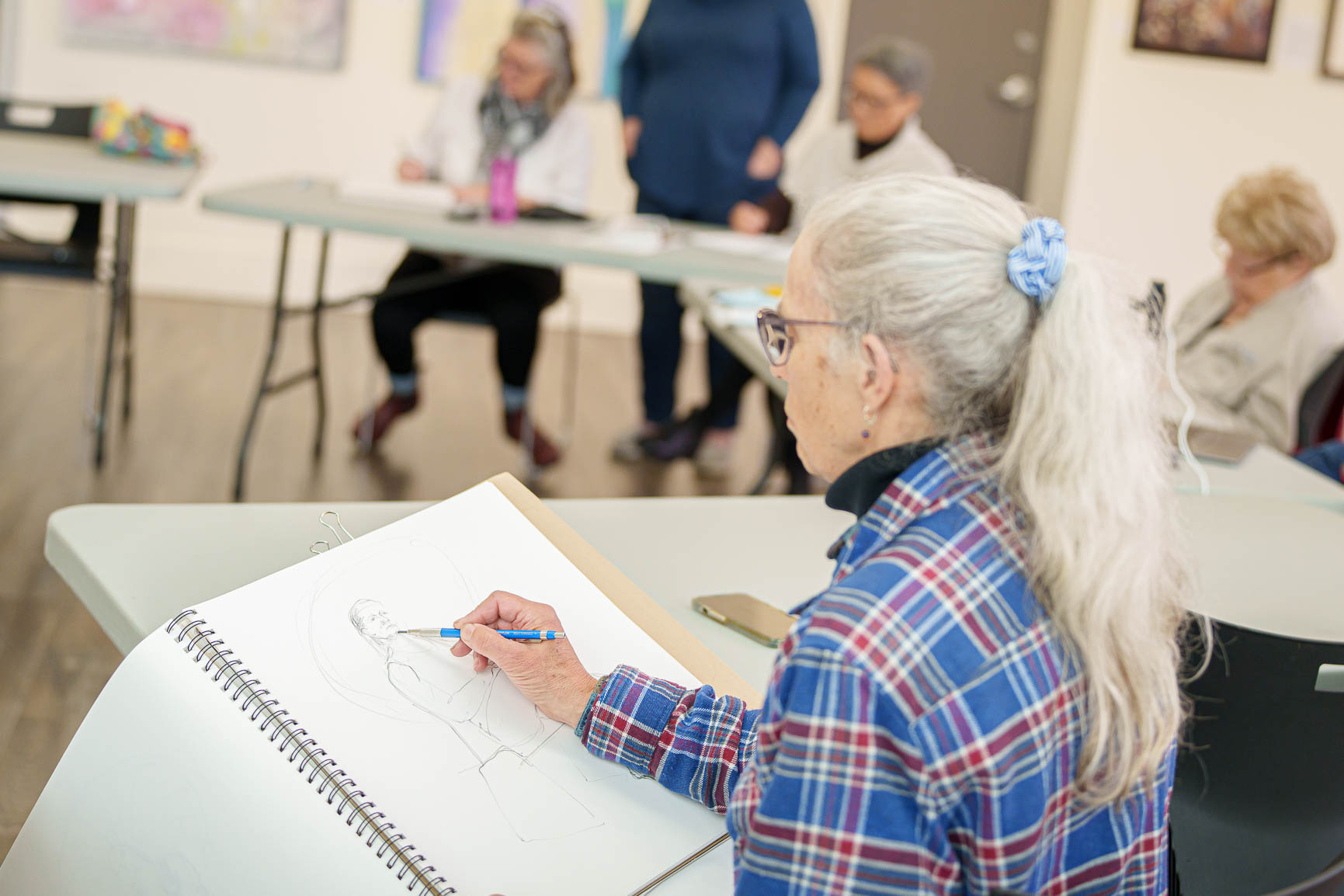 Drawing in the Gallery a woman drawing another woman