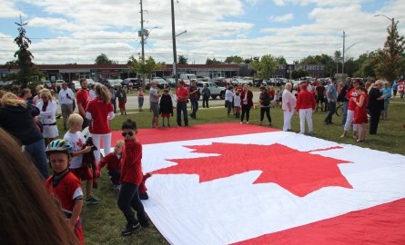 Crowd around a large Canada Flag
