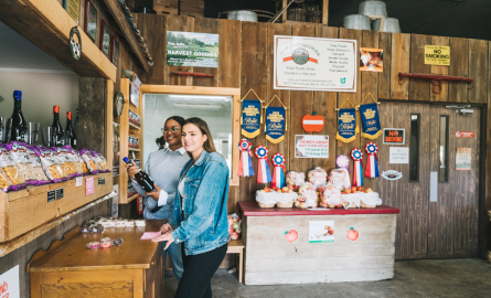 Wheelbarrow Orchards Two women at a farm store looking at some of the products