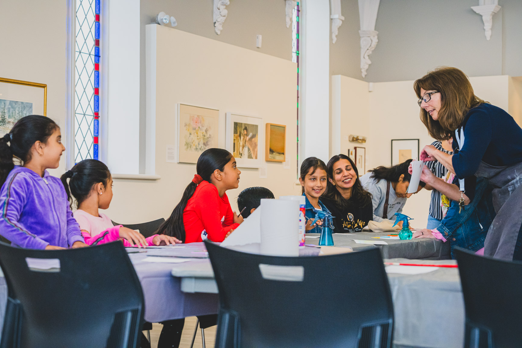 Winter Break Drop-in Art Activities A family doing an art project