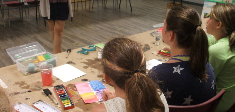 Three girls working on water colour paintings
