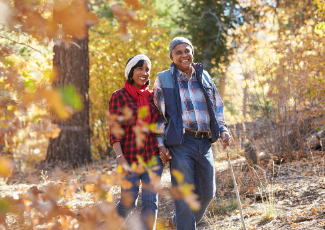 Older couple walking through a trail