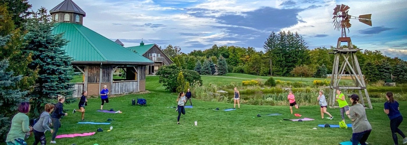Group of people in a fitness glass on a green field