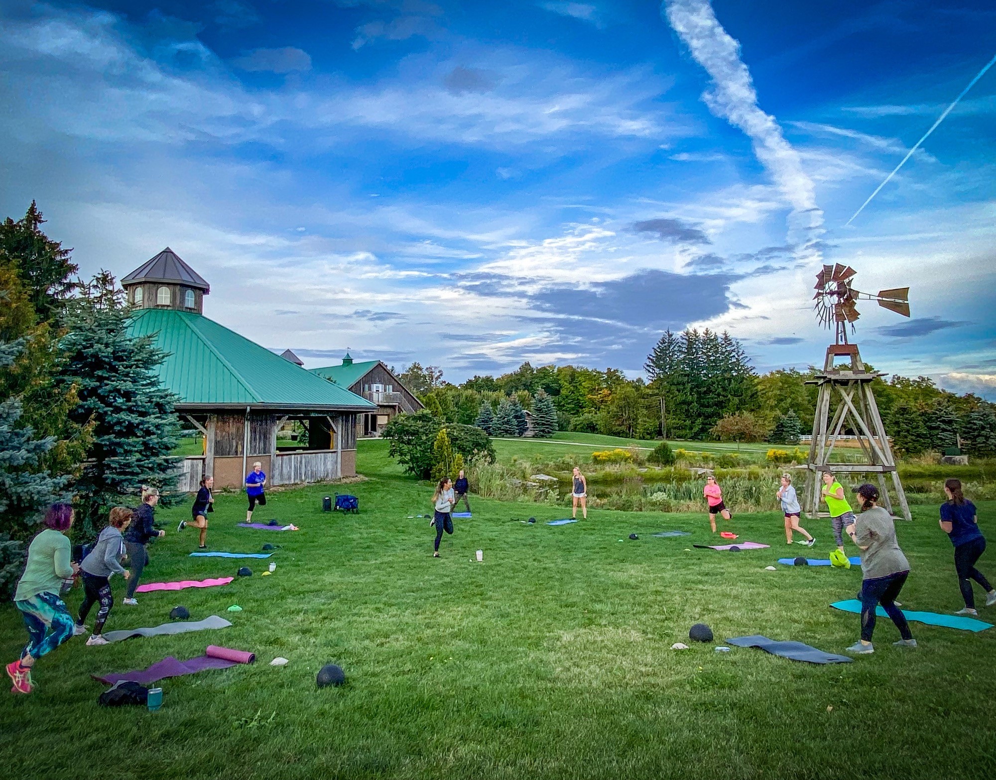 group of people working out in a circle outside