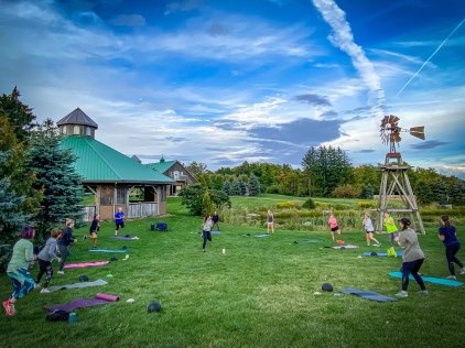 group of women in a circle working out outside