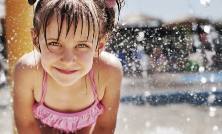 young girl at splash pad in the water