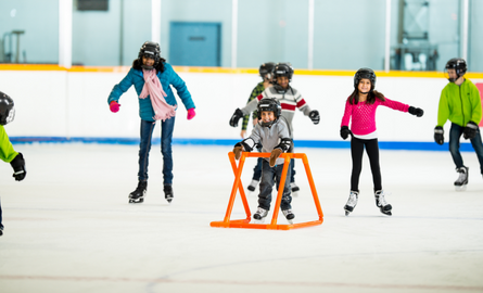 group of children skating in an indoor arena