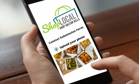 Person holding phone with contest form on the screen