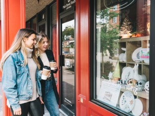 Girls standing outside a storefront window